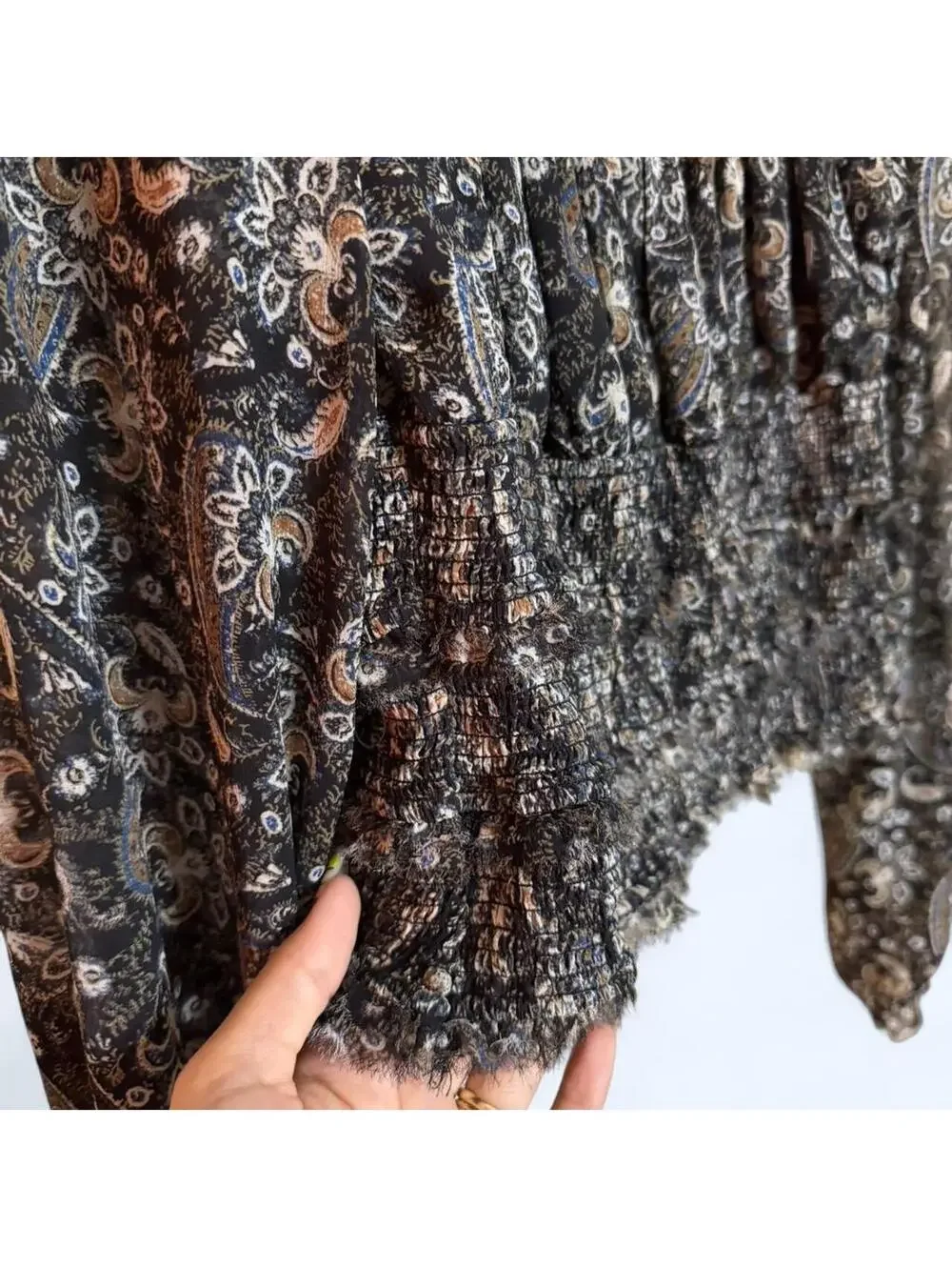Black and grey paisley print blouse with long sleeves and ruffled hem